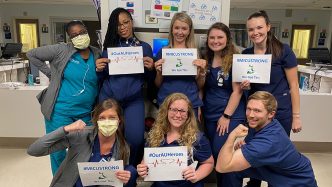 Nurses holding signs