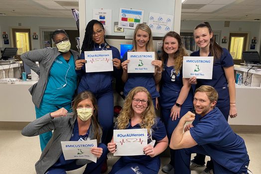 Nurses holding signs
