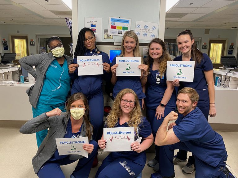 Nurses holding signs