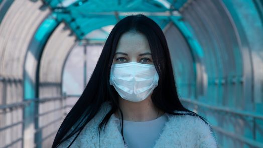 Woman with a surgical mask on her face.
