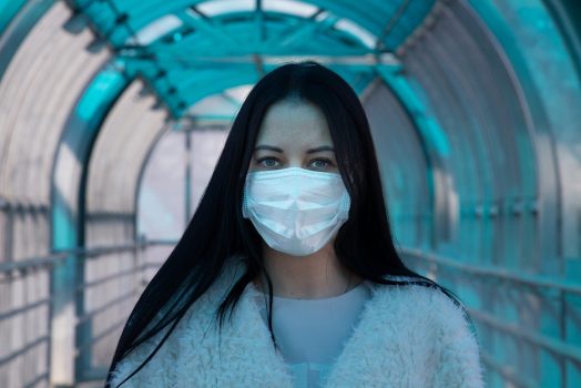 Woman with a surgical mask on her face.