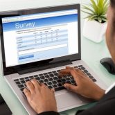 man taking survey on laptop computer