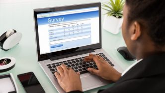 man taking survey on laptop computer