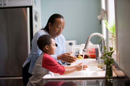 Mother and son washing their hands