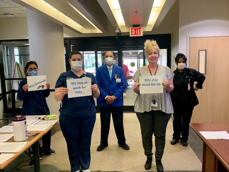 nurses holding signs