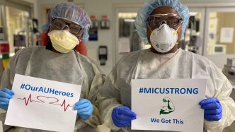 nurses holding signs