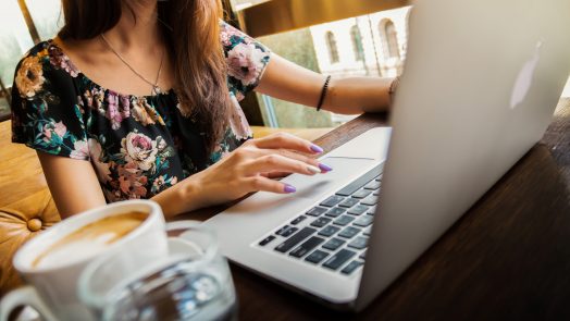 Woman with coffee, laptop