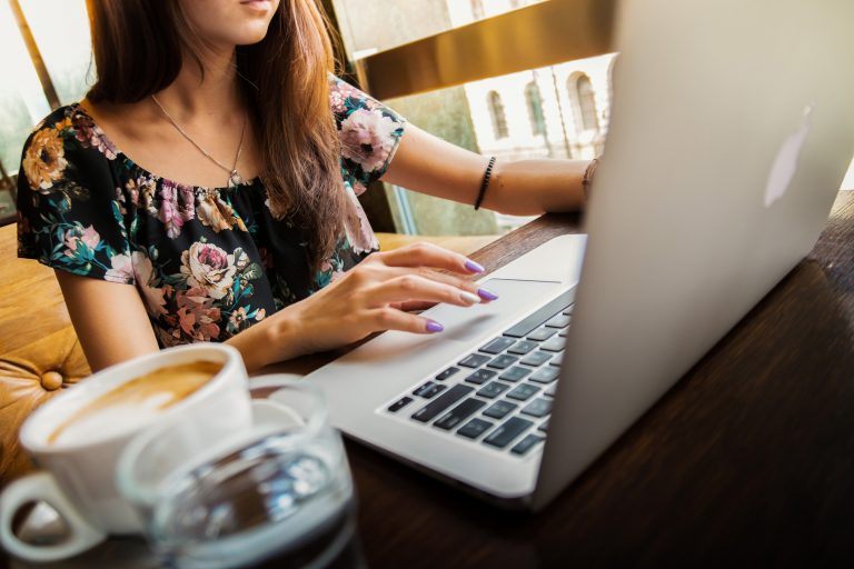 Woman with coffee, laptop