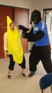 Dr. Gayle Lee, in a banana costume, jokes around with a colleague in a gorilla costume.