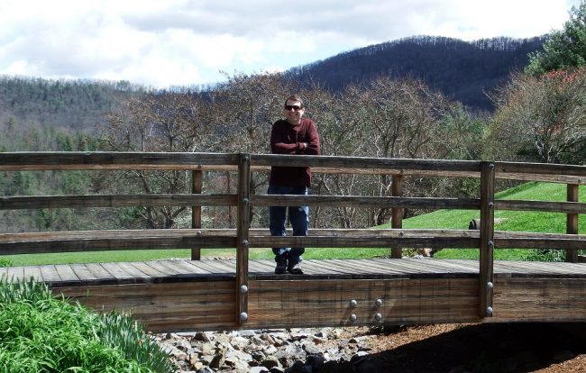 man on foot bridge