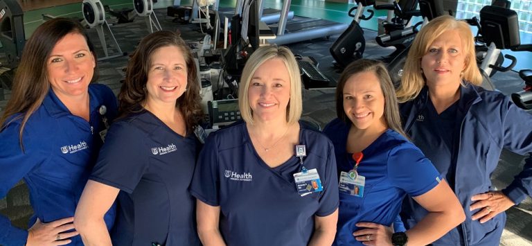 5 women in blue scrubs