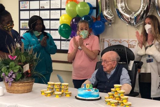 three nurses and man in chair