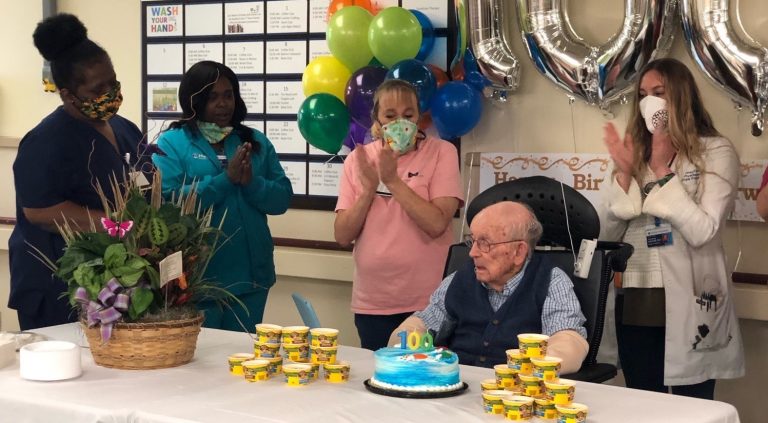 three nurses and man in chair