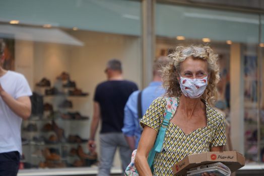 Woman walking with a mask on.