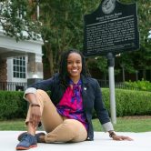 woman sits on sidewalk