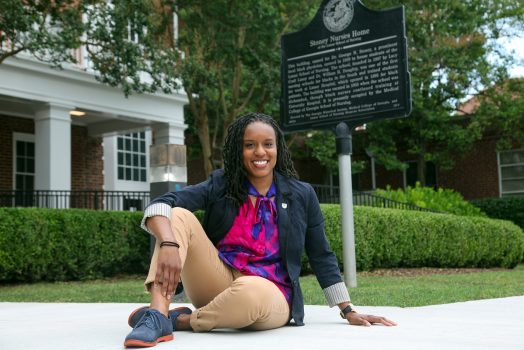 woman sits on sidewalk