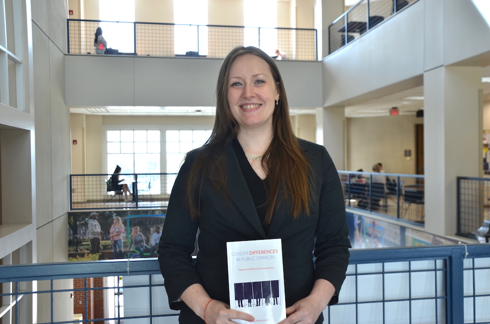 Woman standing with book.