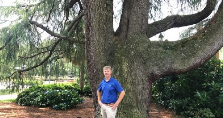 man in front of tree