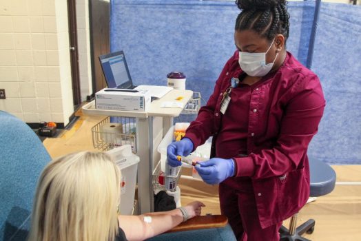 A nurse administering an antibody test.