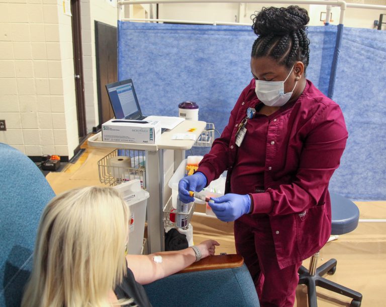 woman sitting and nurse standing