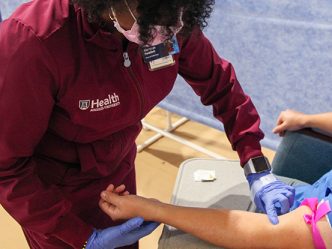 A nurse preparing to draw blood.