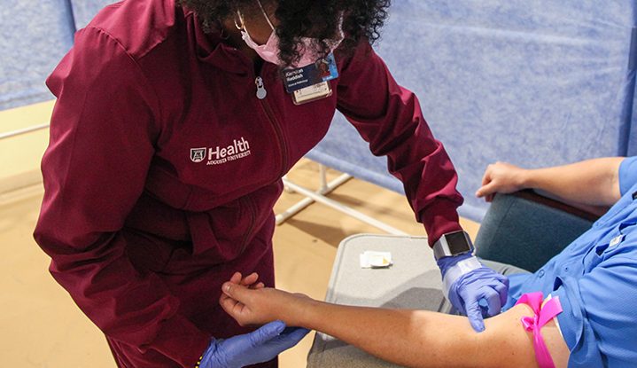 A nurse preparing to draw blood.