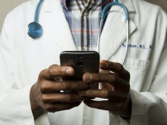 A doctor looking at his phone.