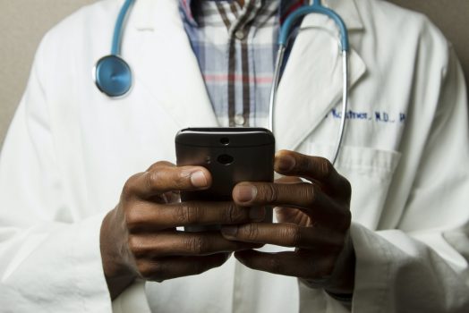 A doctor looking at his phone.