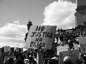 A person holding up a sign during a protest.