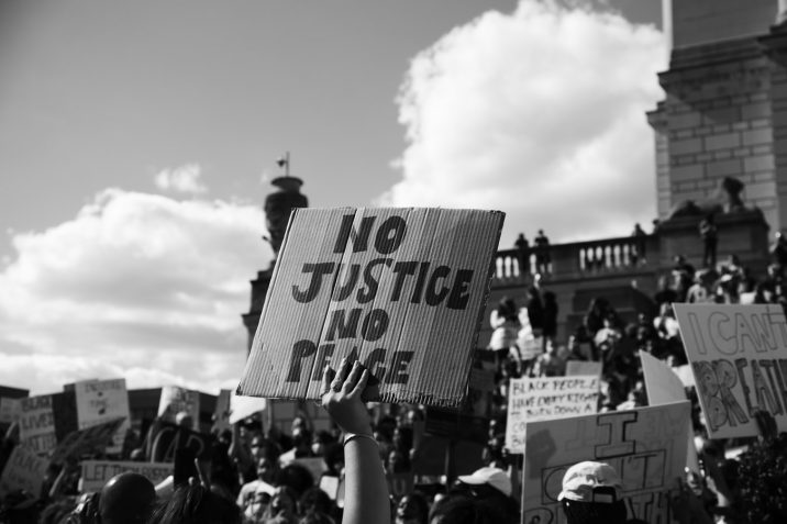 A person holding up a sign during a protest.