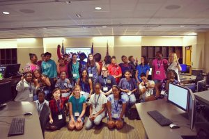 Middle and High school aged girls gathered for a group photo at a Girls Who Code meeting.