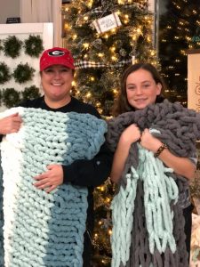 Two women holding blankets