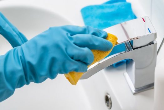 gloved hands clean faucet