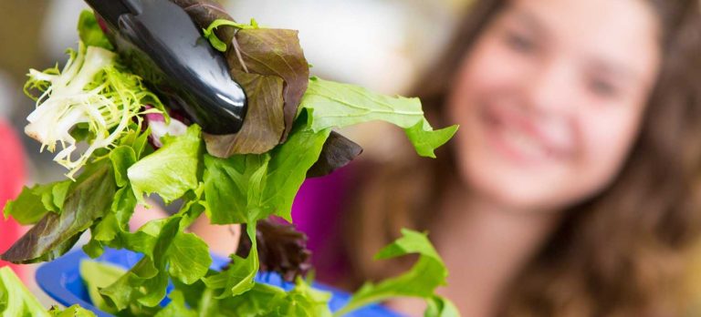 Lettuce picked up by tongs