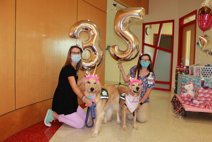 women with dogs and balloons with numbers 3 and 5