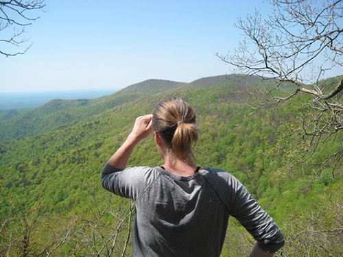 woman looks at mountains