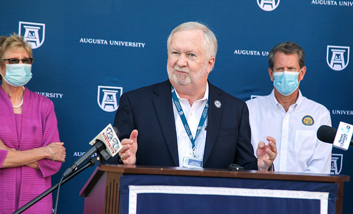Three people at podium
