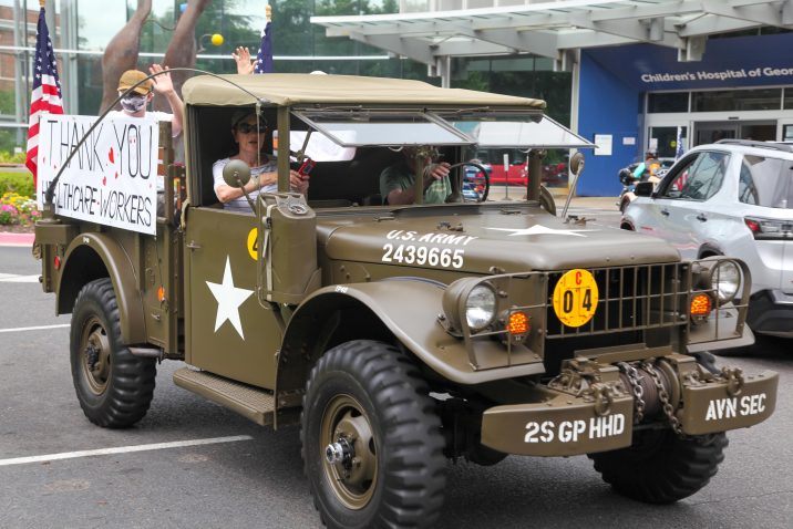 military truck with people inside waving