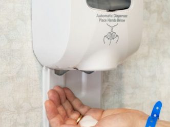 Wall Sanitizer Squirting Soap Into Hand