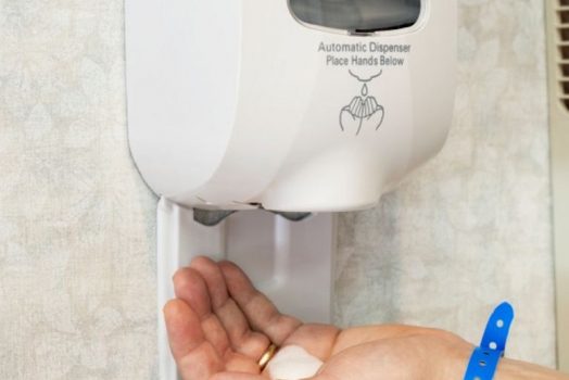 Wall Sanitizer Squirting Soap Into Hand