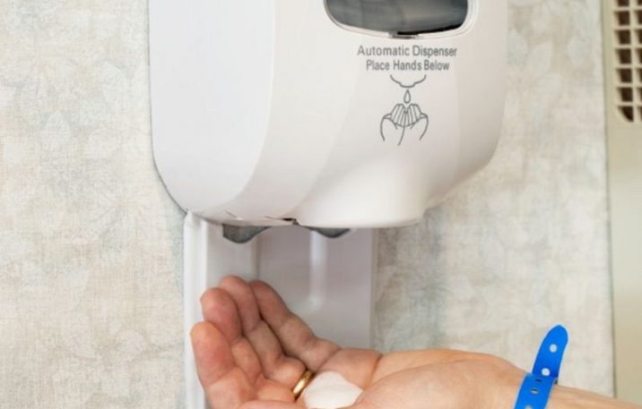 Wall Sanitizer Squirting Soap Into Hand