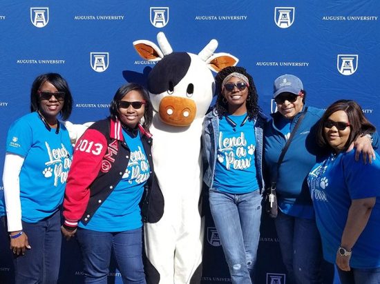 five women and a cow costume