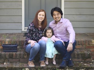 Wife, daughter and husband sit on steps