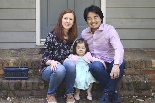 Wife, daughter and husband sit on steps