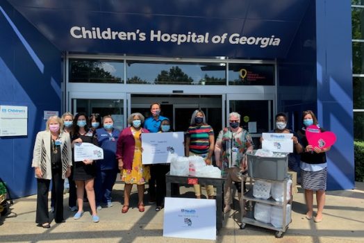 group of people with signs and food, plates