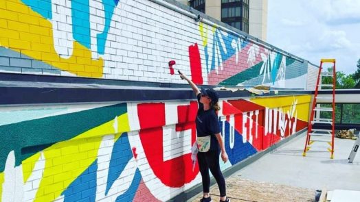 April Henry King paints mural