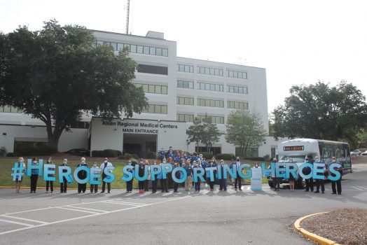 people holding large letter signs