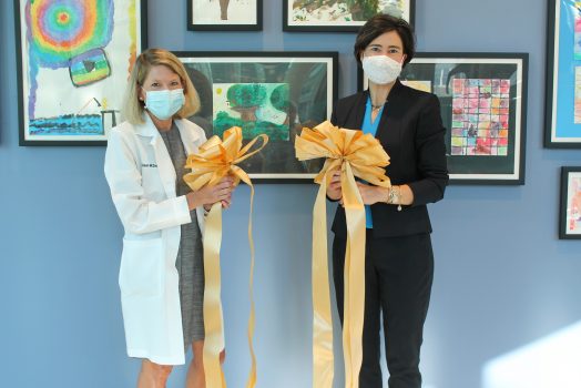two women hold ribbons