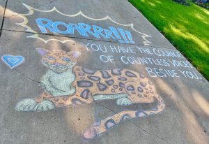 chalk art of a Jaguar, with text surrounding it: "Roarrr!!! You have the courage of countless voices beside you."