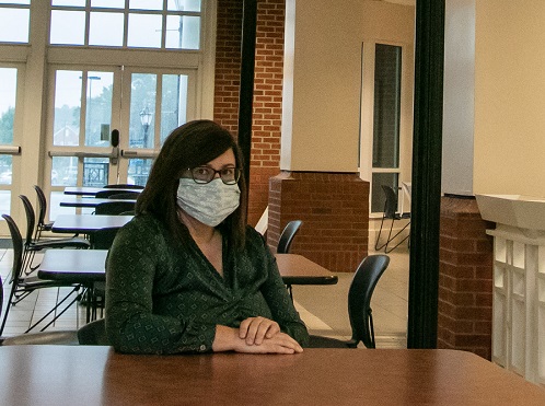 woman at table wearing mask